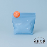 淺藍色帶有拉鍊封口的洗衣粉包裝袋，正面印有白色「asuno」字樣和「LAUNDRY POWDER」等英文及日文說明，左上方有一個橘色圓形貼紙。