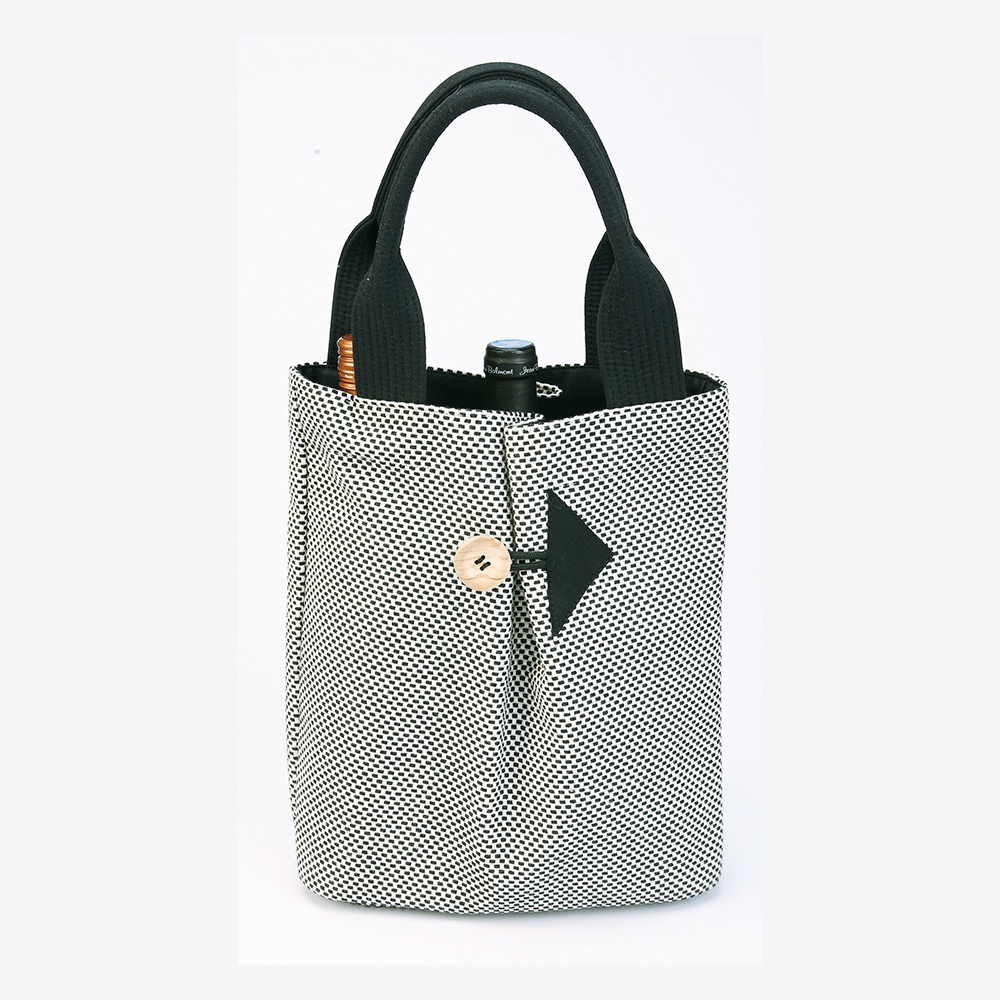黑白細點刺子織直立式收納托特包，配有黑色提把，側面有黑色箭頭裝飾和木製鈕扣。
