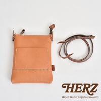 職人手作皮革直式隨身單肩包，淺棕色皮革，附有同色系皮製背帶，包款前方有一個貼袋。