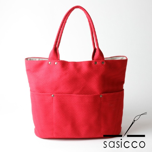 紅色三河木綿刺子織大開口托特包，設有兩個外袋，頂部有金屬扣，內襯為淺灰色。
