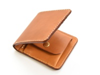 職人手作皮革經典掀蓋扣式雙折短夾，淺棕色皮革，手工車縫，設有掀蓋與銅扣。