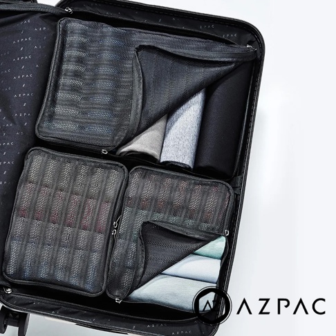AZPAC 黑色旅行收納袋組，內含多個網狀收納袋，整齊擺放於行李箱內，部分收納袋內裝有衣物。