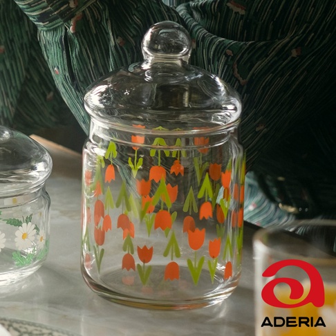 昭和復古玻璃儲物罐，罐身印有橘色鬱金香與綠色葉子圖案，帶有玻璃圓形蓋子。