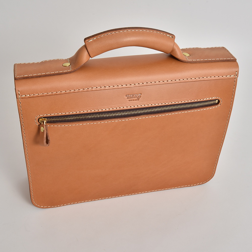 淺棕色皮革學院風兩用公事包，配有頂部提把、金色拉鍊及同色系皮革拉鍊頭，包身縫線清晰，質感自然。
