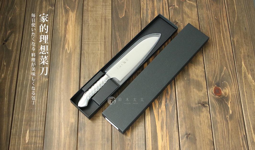 [堺一次] 不鏽鋼三德刀，刀身銀色，手柄帶有菱形紋理，置於黑色刀盒內，整體擺放在木紋背景上。