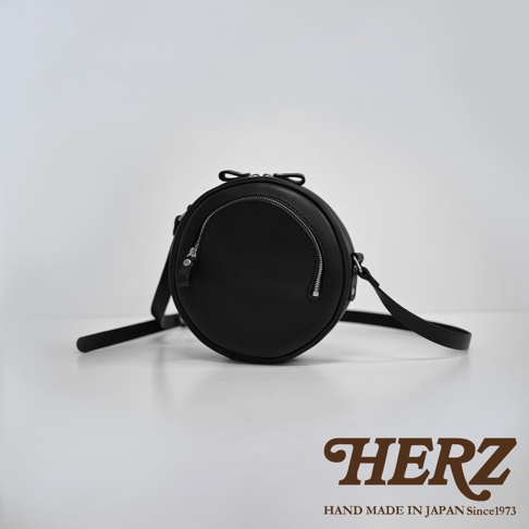 職人手作皮革小圓包 CK-19 S，黑色，圓形設計，正面設有弧形拉鍊隔層，配有可調節肩帶。