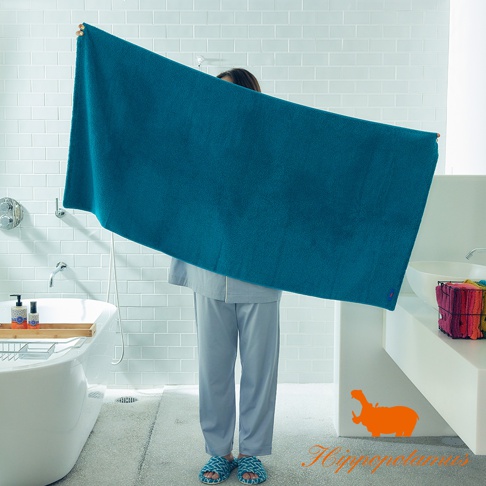 深藍色竹棉混紡厚感大浴巾，質地柔韌，浴巾上有一小小的紅色標籤。