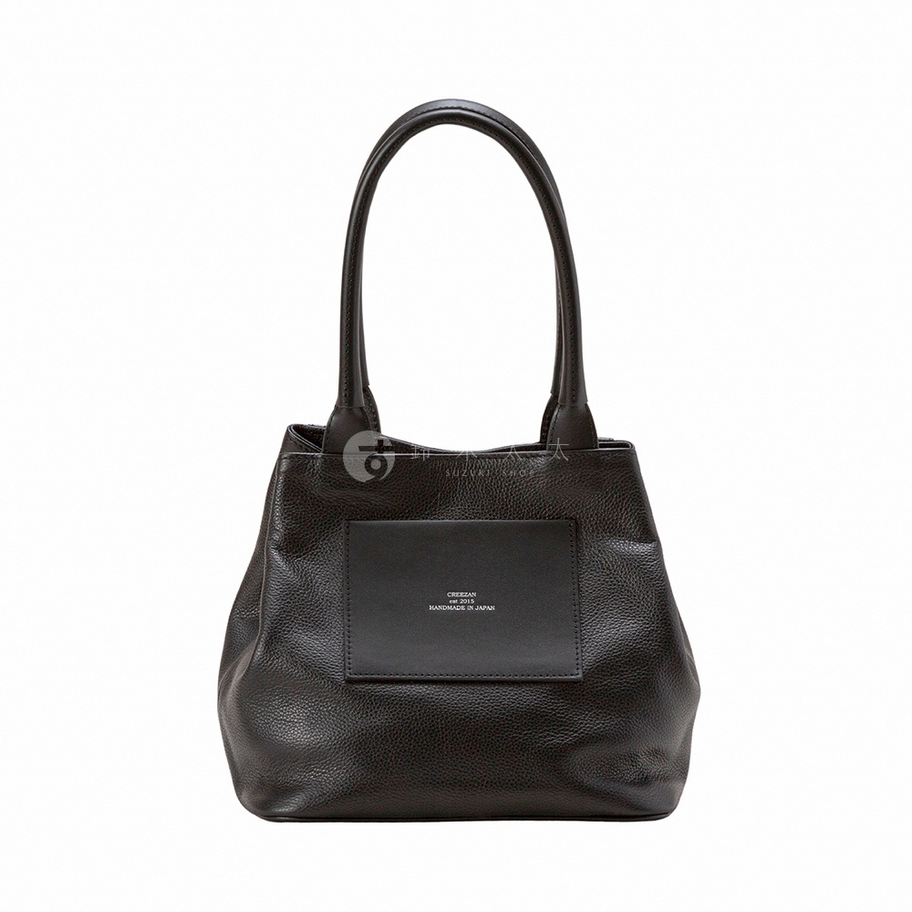 JETTER 方形托特包 CJTE-026，深棕色皮革，帶有雙提把和正面黑色皮革口袋，口袋上印有品牌標誌和「HANDMADE IN JAPAN」字樣。