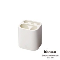 白色簡約雨傘筒架，帶有兩個橢圓形開口，可收納雨傘。材質為塑料，表面光滑。