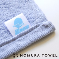 模式B： 淺藍色毛巾一角，標籤印有SUPER ZERO字樣及日文，下方為NOMURA TOWEL品牌名稱