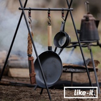 黑色鐵製平底鍋，附有木製手柄，懸掛於黑色三腳架上。旁邊懸掛著兩個尺寸較小的黑色鐵製杯子，以及一個帶有木製手柄的皮革鞘。背景是營火和一個古董水壺。