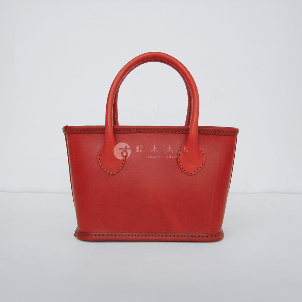 紅色皮革手提包，有雙提把，邊緣及提把處有縫線裝飾。