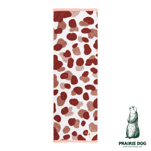 一條長方形的白色毛巾，表面布滿深褐色的不規則圓點紋路，呈現類似豹紋的圖案，毛巾上下兩端邊緣飾有淡粉色滾邊，右下角處藏有一隻貓咪的刺繡圖樣，右下角另有Prairie Dog品牌的標誌與文字。