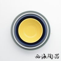 由左至右疊放著四個尺寸遞減的陶瓷深碗，顏色分別為灰、灰藍、深藍、亮黃。