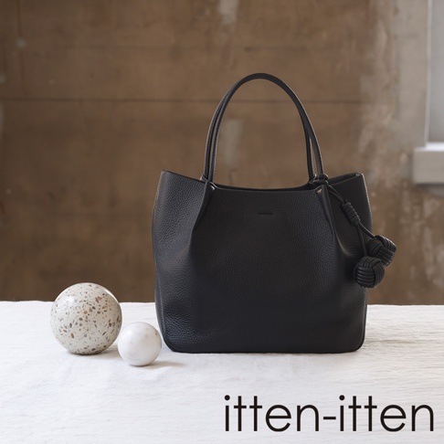 itten-itten Neru 義大利皮革點結吊飾中型托特包，黑色荔枝紋皮革，側邊裝飾兩個皮結，搭配簡約提把。