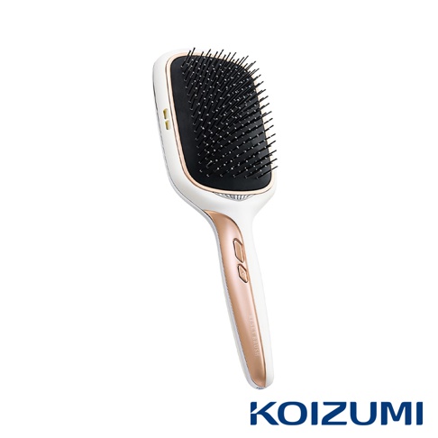 KOIZUMI 正負離子養髮梳 KBE-G520，白色機身搭配玫瑰金邊飾，梳齒密集，手柄有兩個按鈕和一條細長的文字標示。