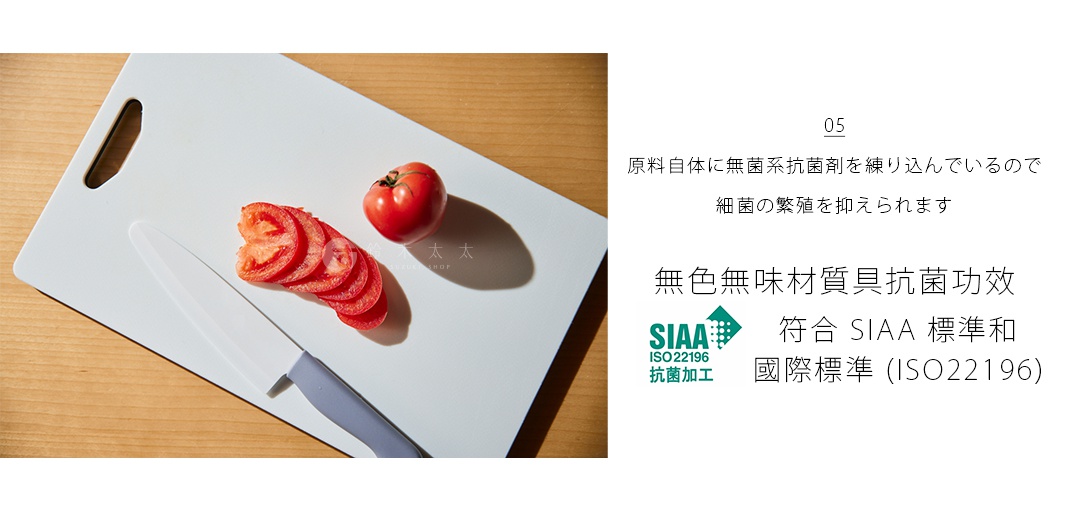 白色抗菌砧板，上面放著一顆番茄及切片番茄，以及一把灰色刀柄的廚刀。