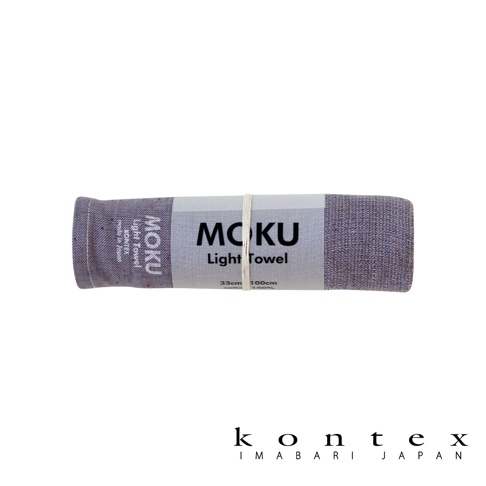 MOKU超速乾輕薄吸水長毛巾，紫色，由100%棉製成，尺寸為33 x 100公分。毛巾捲起並用紙帶綑綁，紙帶上印有MOKU品牌標誌和產品資訊。