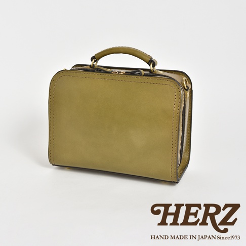 職人手作皮革兩用方形單肩包，橄欖綠色，採用光滑皮革製成，側面有拉鍊設計，頂部有提把。
