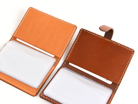 兩件職人手作皮革卡片收納夾，分別為淺棕色與深棕色，皆為開放式設計，內有數個透明夾層，適合收納卡片。