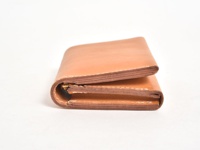 職人手作淺棕色皮革直式卡片收納雙折短夾，具有精緻縫線與金色拉鍊細節。