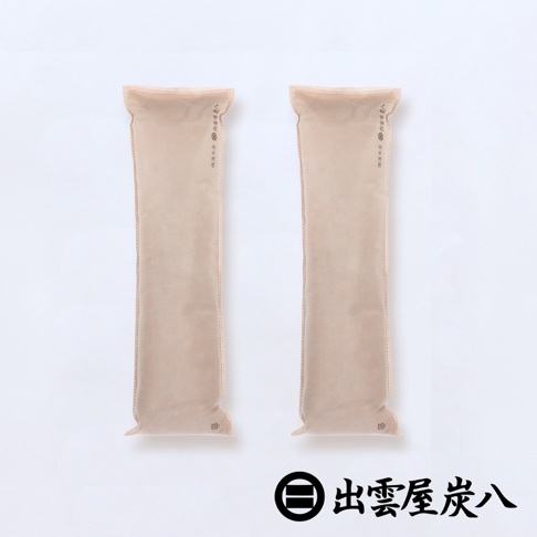 兩件式淺褐色長條形調濕木炭包，材質為無紡布，表面有細微網格紋理，印有黑色日文說明和品牌標誌。