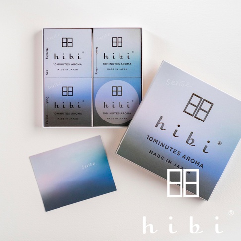圖片文字：Sense hibi 10MINUTES AROMA MADE IN JAPAN Morning Sea Noon River Dusk Forest 圖片中展示一套hibi品牌香氛火柴禮盒，包含一個外盒、一張漸層感的小卡，以及打開後內部整齊排列四個小盒，每個小盒上皆標示著對應的場景名稱與hibi品牌logo，整體色調呈現從淺藍到深藍的漸層風格。