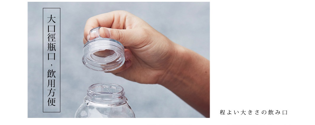 手持透明塑膠瓶蓋，瓶口為寬口設計，瓶身為透明塑膠材質。