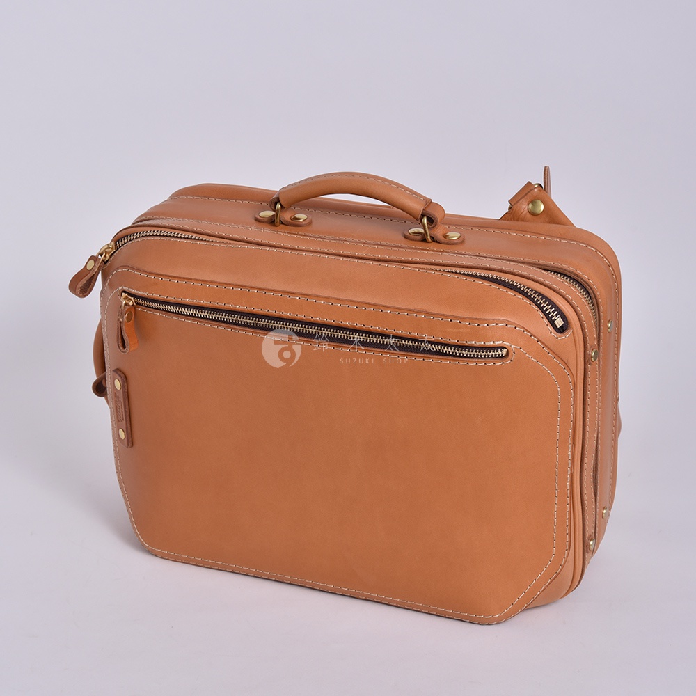 職人手作皮革兩用商務後背包 R-33，採用淺棕色皮革製作，設計簡潔，配有頂部提把、多個拉鍊隔層，展現質感與實用性。