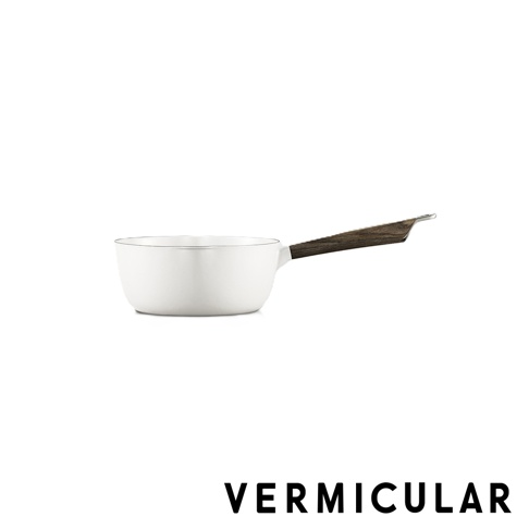 一款白色極簡設計的VERMICULAR琺瑯鑄鐵雪平鍋，配有深色木質把手，整體造型優雅現代，呈現於純白背景中。