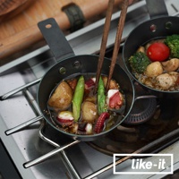 直火專用萬能調理把手鐵杯，黑色，盛有燉煮的馬鈴薯、蘆筍、章魚塊和香料，旁邊是另一只裝有相似食材的鐵杯，由木筷夾取食材。