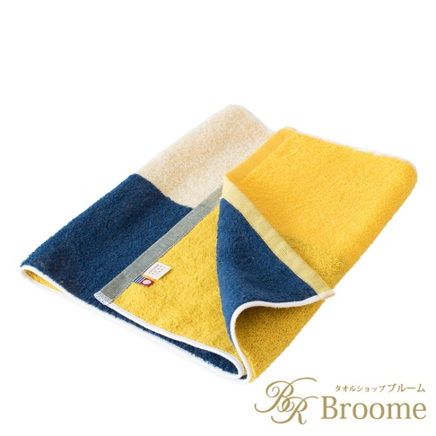 今治KAKUTERU純棉毛巾，採撞色設計，由米白、深藍與亮黃三色色塊拼接而成，材質柔軟舒適。