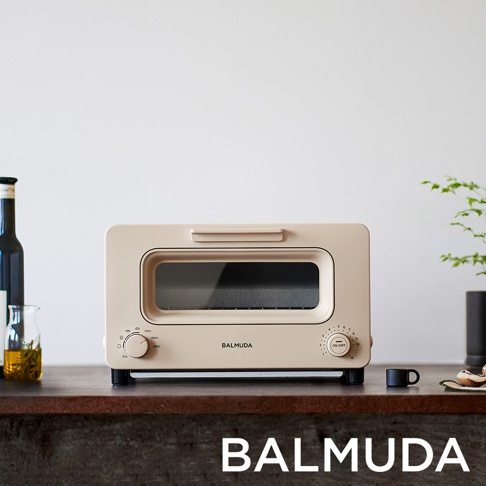 奶茶色蒸氣烤麵包機，配有玻璃門、兩個旋鈕和品牌標誌。