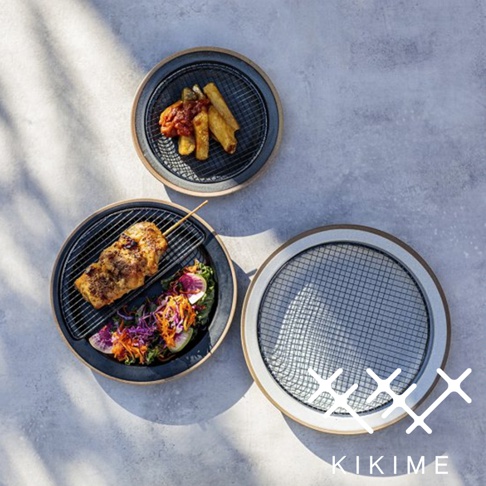 兩個美濃燒瀝油餐盤，其中一個盤子裡有烤雞肉串和沙拉，另一個盤子裡是薯條和醬料，盤子皆配有黑色網架。