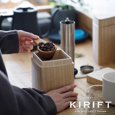 天然桐木製成的咖啡豆保存盒，淺木色，方形盒身，搭配木製咖啡豆量勺，勺內盛有烘焙好的咖啡豆。