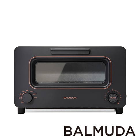 黑色蒸氣烤麵包機，設有銅色邊框，上方有提把，正面有長方形玻璃視窗，下方有兩個旋鈕，左側旋鈕標示溫度，右側旋鈕標示時間。