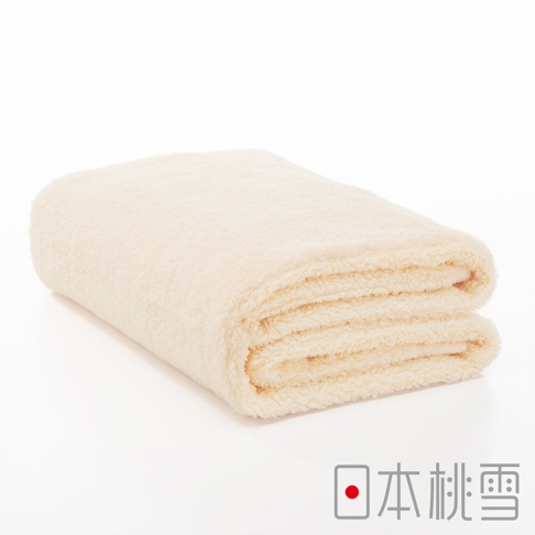 一條折疊的淺米色今治超長棉浴巾，質地柔軟蓬鬆，邊緣有清晰的紋理。