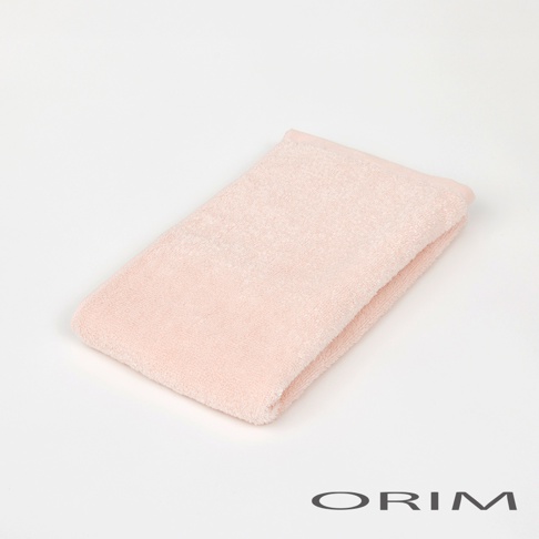 粉紅色今治柔彩浴巾，質地柔軟，邊緣有細緻的織紋，呈現簡約的摺疊樣式。