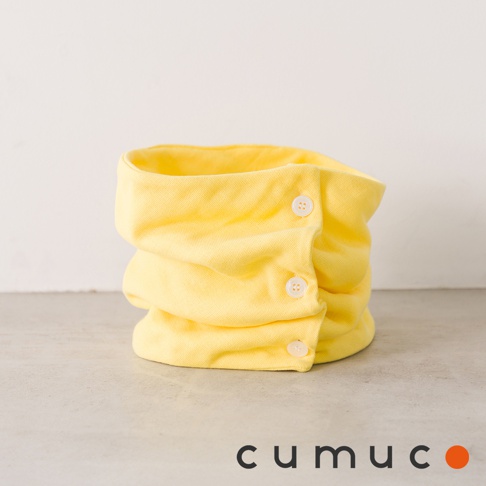 黃色CUMUCO八層紗保暖頸套，附有白色鈕扣，放在淺色背景的桌面上