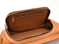 職人手作皮革拉鍊旅行斜背包 (F-7)，展示了棕褐色皮革材質，包含一個頂部拉鍊開口，內部設有拉鍊夾層，整體以白色縫線裝飾，風格簡約。