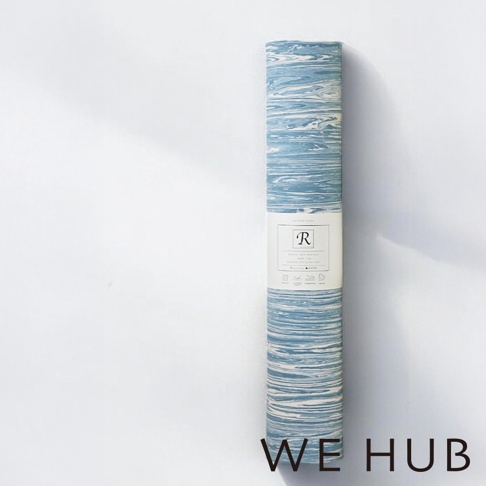 WE HUB 品牌名、R logo 與捲起來的藍色與白色大理石紋路瑜珈墊