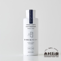 白色塑膠瓶裝的 C-series 鏡面水垢清潔劑，瓶身印有品牌名稱 KIMURA SOAP'S CRAFTSMANSHIP SINCE 1924，以及鏡子清潔圖示、日文「鏡の鱗状痕クリーナー」和英文「WASHING LIQUID FOR MIRROR」，下方標示「洗淨 150g」與「MADE IN JAPAN」。瓶蓋處有深藍色標籤。