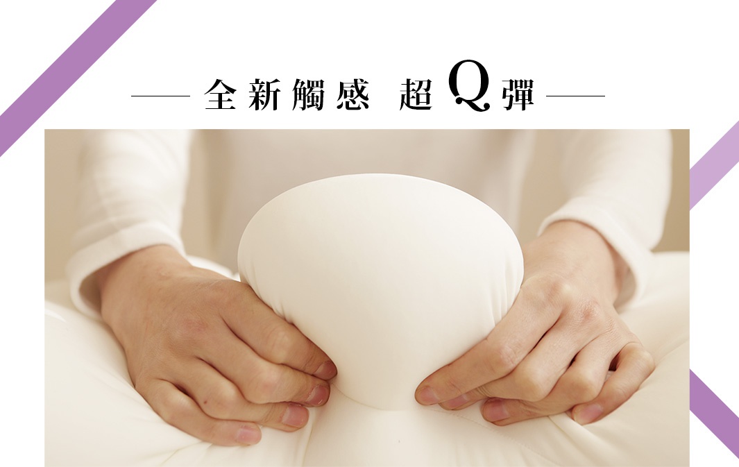 一雙手正在擠壓一個白色、柔軟、Q彈的枕頭，枕頭表面光滑，呈現出良好的回彈性。