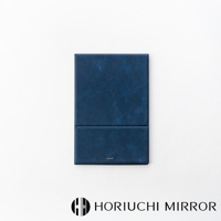 NAPURE 桌上型2Way折疊化妝鏡，深藍色皮革紋理外殼，可折疊設計，中間有細微的摺痕，上方印有小字品牌標誌。