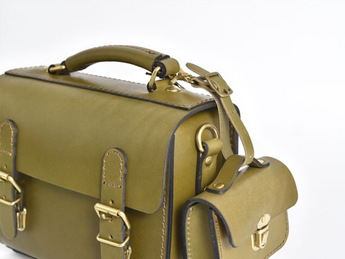 橄欖綠皮革手提包，帶有可調式肩帶、金色搭扣和側邊小口袋。