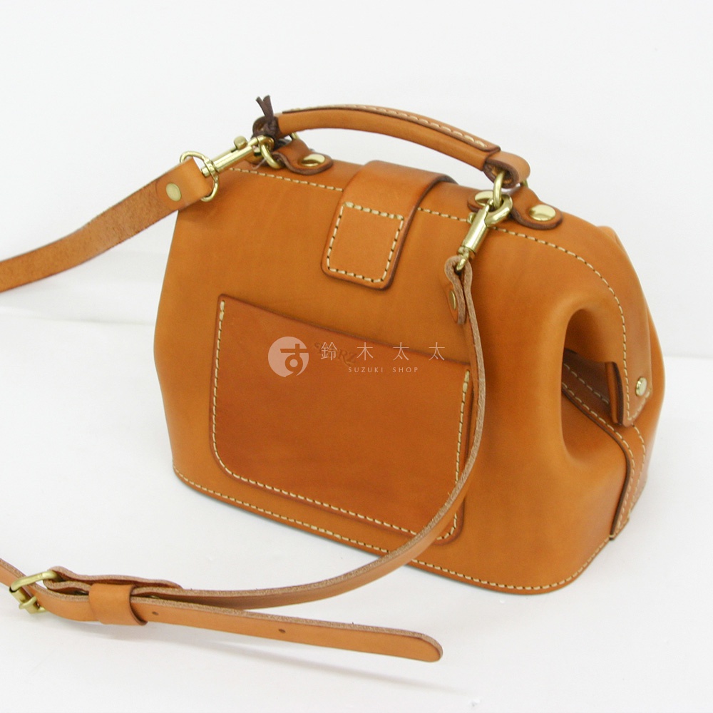 職人手作皮革方型迷你醫生包，採用棕褐色皮革製成，配有頂部提把、可拆卸斜背帶、金色金屬扣環及外側方形口袋，車縫線清晰。