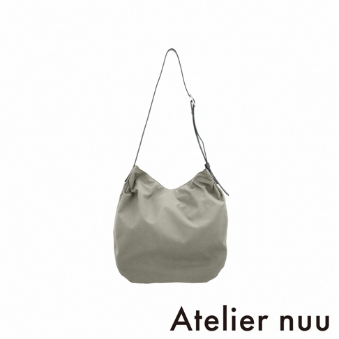 Atelier nuu ssent 肩背托特包，淺綠色帆布材質，整體呈水桶狀，具有皺褶感，附有一條細長的黑色肩帶。