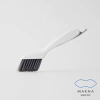 白色塑膠手柄縫隙清潔刷，帶有深灰色刷毛，刷頭角度傾斜，便於清潔狹窄縫隙。