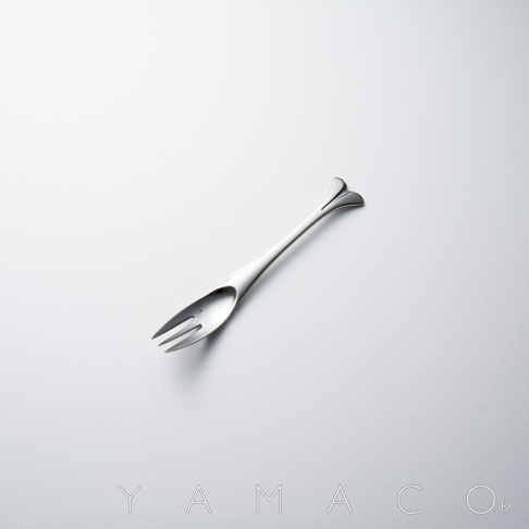 銀色不鏽鋼材質的點心叉，叉頭呈魚形，握柄末端有兩片葉子狀的裝飾，整體設計精緻優雅。