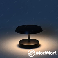 霧黑色 LED T-Light LOUNGE 工型造型燈，圓形底座，圓形燈罩，由一支短柱連接。燈光從下方發出，照亮桌面。